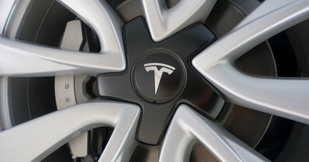Close-up of a Tesla alloy wheel and brake caliper
