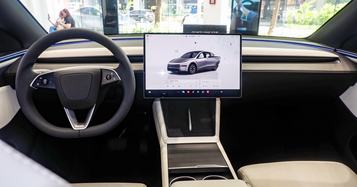 Tesla Model Y interior with cream front seats and center touchscreen